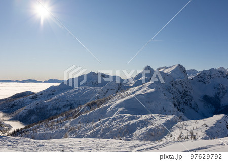 Winter mountains covered with snow landscape over clouds 97629792
