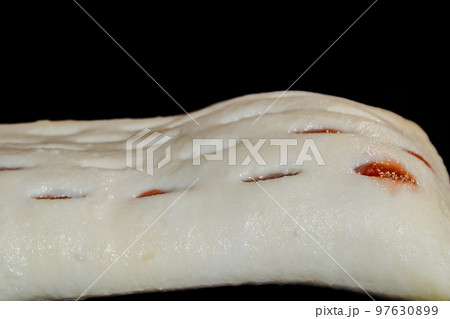 Uncooked homemade bun in electric oven, black background Uncooked homemade bun in electric oven, black background 97630899