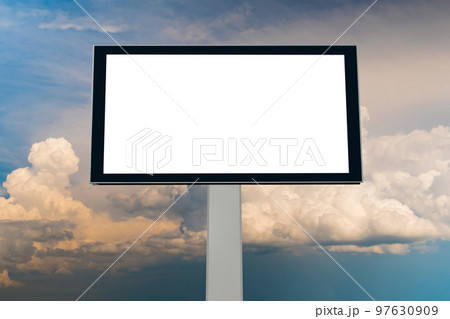 Blank white billboard against warm sunset sky with clouds - mock up 97630909