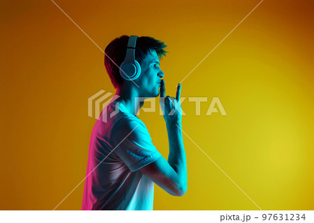 Young man listening to music with headphones 97631234