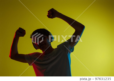 Young man listening to music with headphones 97631235