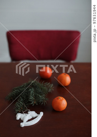 Christmas Toy horse, tangerines and pine cone. Winter holiday items for home decor. Flat lay 97631944
