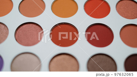Selective focus of eyeshadow palette with various colors in pearly and matte closeup 97632065
