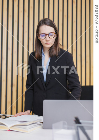 business woman is working on laptop in office, job with papers. confident business lady 97632083