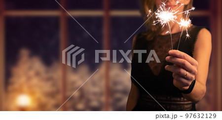 woman holding sparkles Christmas or New Year woman holding sparkles Christmas or New Year 97632129