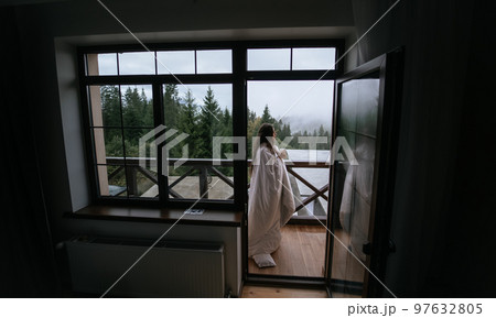 Woman drinking tea on cozy balcony of a country house. 97632805