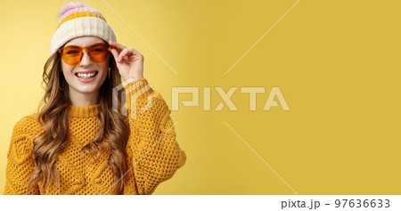Friendly-looking happy outgoing attractive girl laughing joyfully having funny interesting conversation checking sunglasses relaxing ski resort having fun resting together friends, yellow background Friendly-looking happy outgoing attractive girl laughing joyfully having funny interesting conversation checking sunglasses relaxing ski resort having fun resting together friends, yellow background 97636633