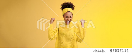 Excited thrilled beautiful young girl student yelling happily clench fists victory triumph pose dancing celebrating acception popular university standing satisfied achieve goal dream come true 97637112