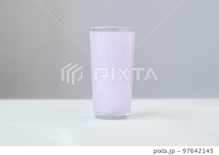 Glass with pink electrolytes dissolved in water for and during sports Glass with pink electrolytes dissolved in water for and during sports 97642145