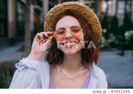 Young woman with toothy smile in outdoors 97642348