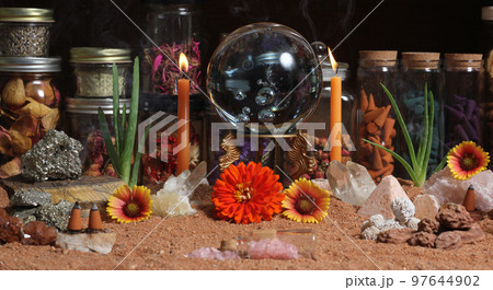 Crystal Ball With Candles and Chakra Stones on Australian Red Sand 97644902