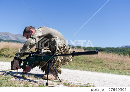 Special operations soldiers team preparing tactical and communication gear for action battle. Long distance sniper team in checking gear for action Special operations soldiers team preparing tactical and communication gear for action battle. Long distance sniper team in checking gear for action 97649505