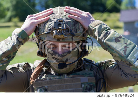 Special operations soldiers team preparing tactical and communication gear for action battle. Long distance sniper team in checking gear for action 97649924