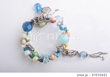 jewerly bracelet with semiprecious stones around  white background. top view 97650682
