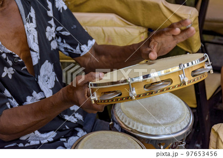 Detail of musician playing tambourine in the streets of Pelourinho in Salvador Detail of musician playing tambourine in the streets of Pelourinho in Salvador 97653456