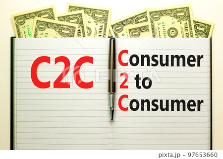 C2C consumer to consumer symbol. Concept words C2C consumer to consumer on white note on a beautiful background from dollar bills. Business and C2C consumer to consumer concept. Copy space. 97653660