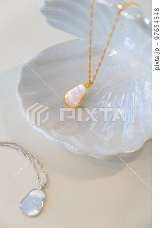 Golden and silver chain pearl necklaces on white Golden and silver chain pearl necklaces on white 97654348