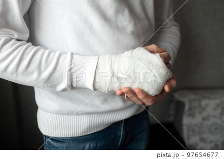 A man's broken arm in a cast A man's broken arm in a cast 97654677