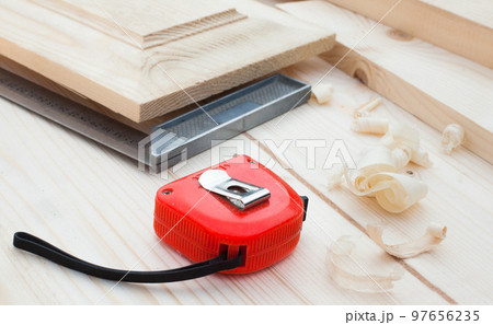 A measuring tape and a square. 97656235