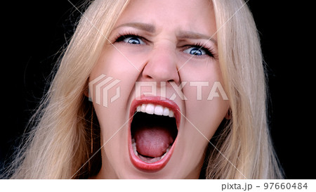 Angry woman yells in rage as she looking at...の写真素材 [97660484] - PIXTA