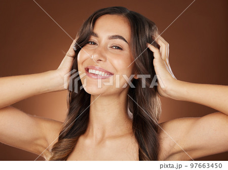 Face portrait, hair care and beauty of woman in studio isolated on a brown background. Wellness, hairstyle and aesthetics of female model with healthy and long hair after salon treatment for growth. 97663450