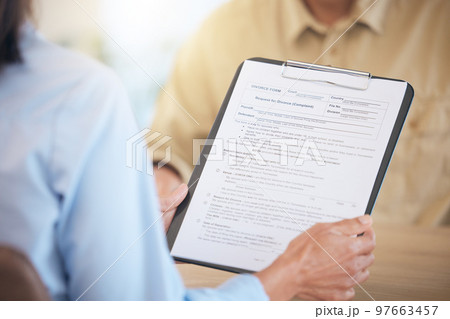 Contract, divorce and documents on clipboard, marriage fail with man and woman reading legal paperwork. Agreement, compliance and review document for separation by law, partnership end and family law 97663457