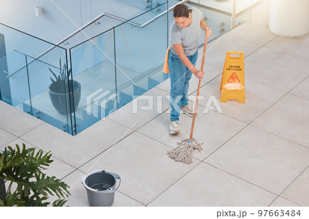 Cleaning service, office building or woman mopping floor with warning sign for job safety compliance. Bucket, bacteria or girl cleaner working on wet floor for dirty, messy or dusty tiles on ground 97663484
