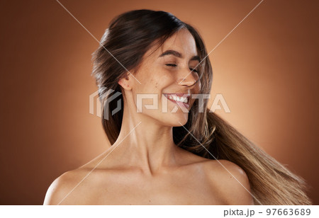 Hair, beauty and skincare with a model woman in studio on a brown background for natural or keratin treatment. Face, haircare and salon with an attractive young female posing to promote a product Hair, beauty and skincare with a model woman in studio on a brown background for natural or keratin treatment. Face, haircare and salon with an attractive young female posing to promote a product 97663689