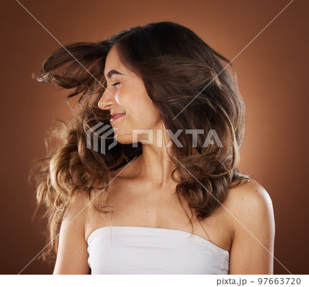 Hair, beauty and skincare with a model woman in studio on a brown background for natural or keratin treatment. Face, haircare and salon with an attractive young female posing to promote a product Hair, beauty and skincare with a model woman in studio on a brown background for natural or keratin treatment. Face, haircare and salon with an attractive young female posing to promote a product 97663720