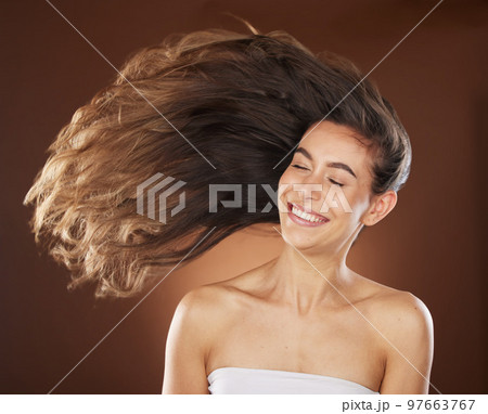 Hair, beauty and skincare with a model woman in studio on a brown background for natural or keratin treatment. Face, haircare and salon with an attractive young female posing to promote a product 97663767