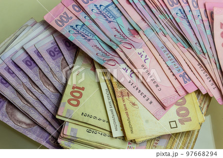 Paper money different denominations, Ukrainian hryvnia in denominations 50,100, 200 hryvnias, new money, background with scattered banknotes 97668294