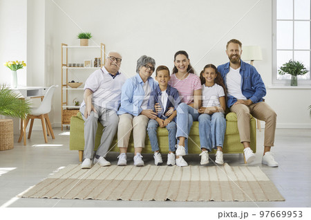 Big happy family sitting on sofa in cozy room 97669953
