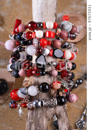 different bracelets with black and red semipreciouse stones with natural lava, shungite, hematite, rhodonite, coral and others. top view different bracelets with black and red semipreciouse stones with natural lava, shungite, hematite, rhodonite, coral and others. top view 97673931