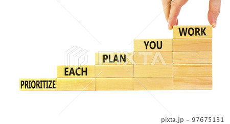 Prioritize each plan you work symbol. Concept words Prioritize each plan you work on blocks on beautiful white background. Businessman hand. Business prioritize each plan you work concept. Copy space 97675131