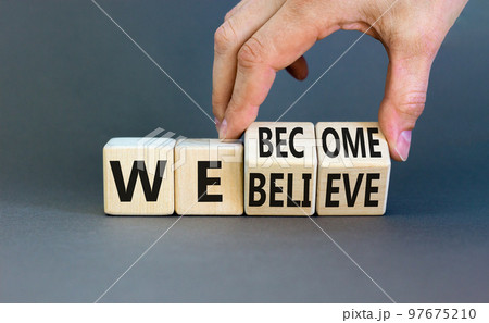 We become or believe symbol. Concept word We believe We become on wooden cubes. Beautiful grey table grey background. Businessman hand. Business we become or believe concept. Copy space. 97675210