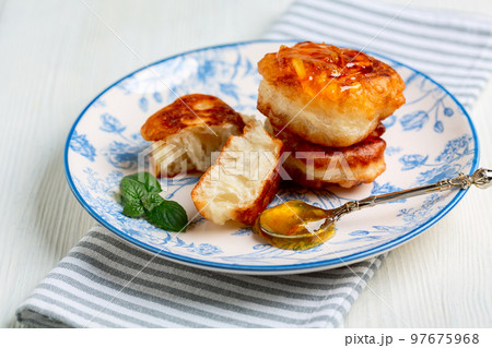 Homemade fritters (pancakes) with jam. 97675968