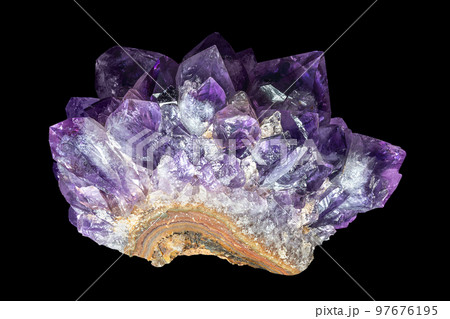 Amethyst, part of a geode, on black background. A variety of quartz, with natural dark purple and violet color. A semiprecious stone, often used in jewelry and traditional birthstone for February. Amethyst, part of a geode, on black background. A variety of quartz, with natural dark purple and violet color. A semiprecious stone, often used in jewelry and traditional birthstone for February. 97676195