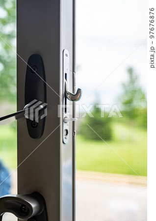 Handle, locking hardware, and jam to a sliding glass and screen door. 97676876