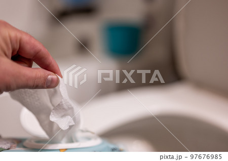 Disposable wipes being flushed down a toilet where they can cause clogging and problems with wastewater treatment. 97676985