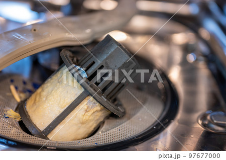Food and grime coating a dishwasher filter that has been removed for maintenance and cleaning. Food and grime coating a dishwasher filter that has been removed for maintenance and cleaning. 97677000