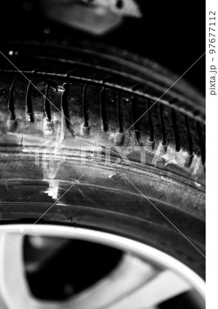 screw protruding from the tread of a tire causing a flat. 97677112