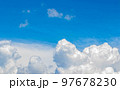 White cumulus clouds in the blue sky, illuminated by the bright spring sun. 97678230