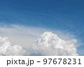 White cumulus clouds in the blue sky, illuminated by the bright spring sun. 97678231