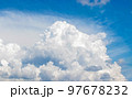 White cumulus clouds in the blue sky, illuminated by the bright spring sun. 97678232