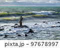 Statue of Neptune by  an unknown author in the sea against the waves. Ostia, Lazio, Italy. 97678997