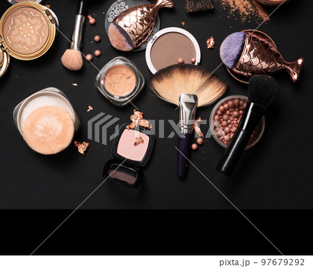 luxery Set of bronze powder with makeup brushes on black background luxery Set of bronze powder with makeup brushes on black background 97679292