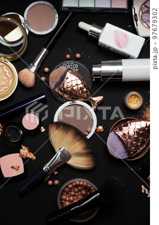 Set of bronze powder with makeup brushes on black background Set of bronze powder with makeup brushes on black background 97679302