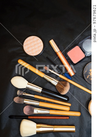Set of make up brushes  with cosmetics on black background 97679621