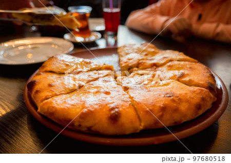Close up of fresh Ossetian pie with beef meat without one piece 97680518