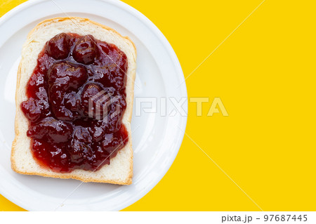 Sliced bread with strawberry jam 97687445